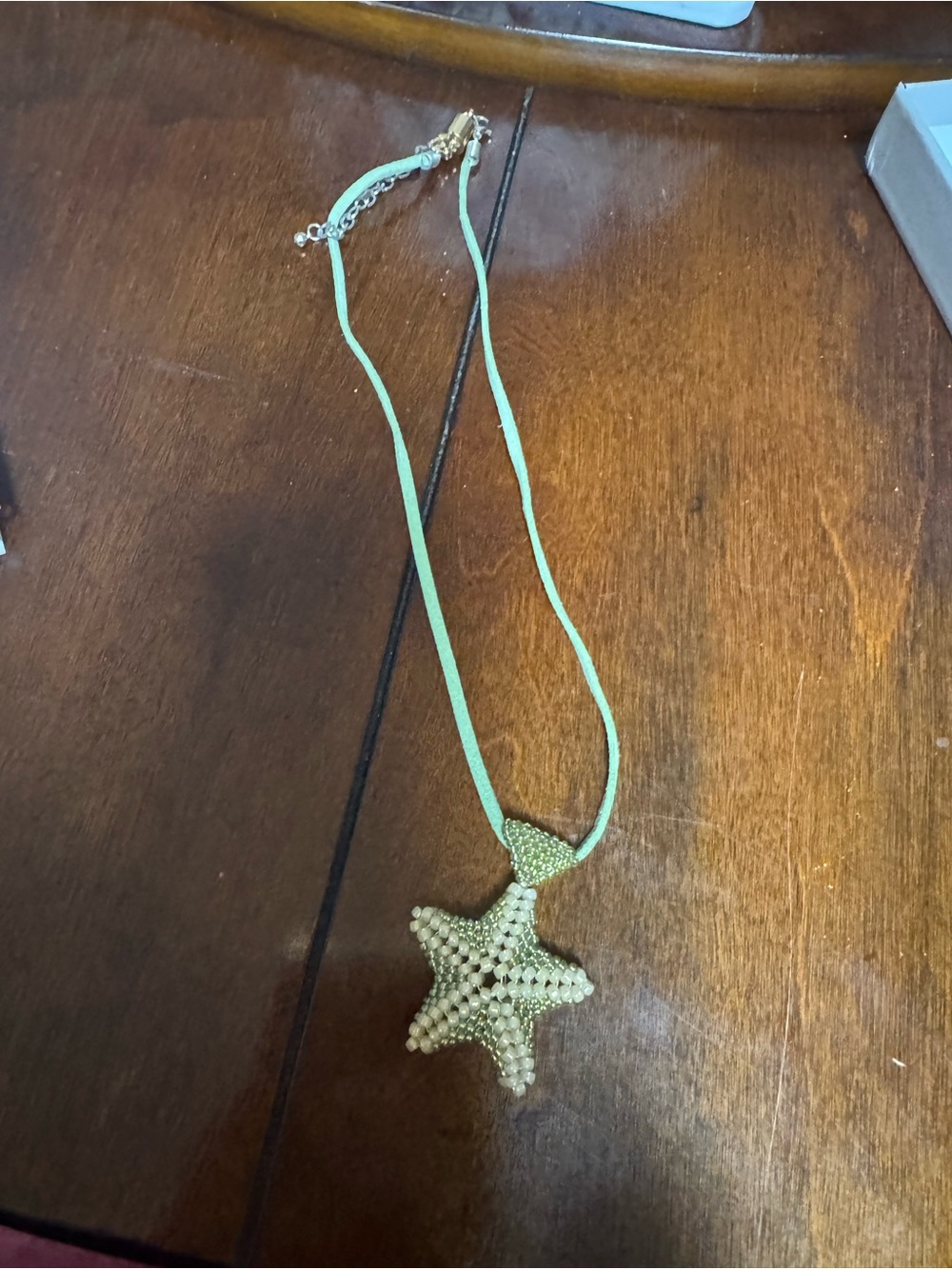 beaded starfish pendant necklace featuring a light green cord